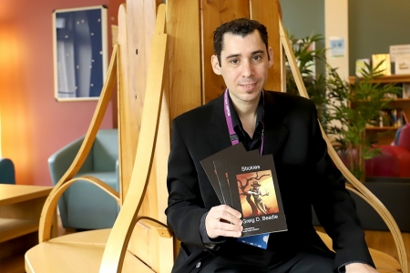 Greig with his book.jpg